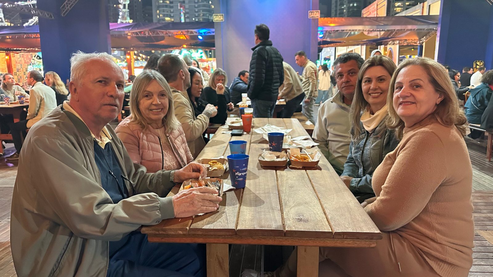 Aldo e sua família aproveitando a gastronomia da festa. (Foto: Heloísa dos Santos)